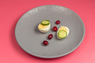 front view boiled eggs with cucumbers inside plate on pink background food meal egg plant raw color phoot