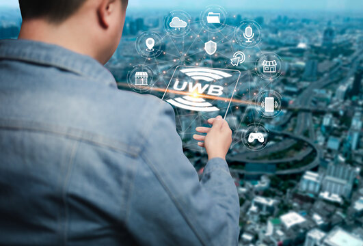 An Asian man is using a tablet to connect ultra-wideband UWB as a short-range radio communication technology. Works similarly to Bluetooth and Wi-Fi.