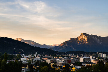 the impressive view of Hallstatt in the early morning when sunlight hits the golden peaks in the background. It is a beautiful romantic moment.