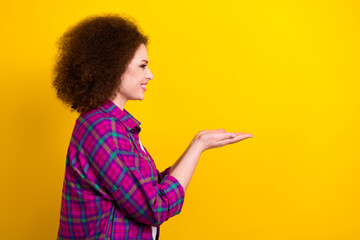 Photo of funky pretty woman dressed plaid shirt holding arms empty space isolated yellow color background