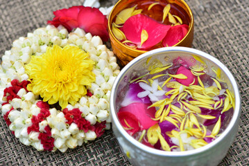 Jasmine water and rose petals in a bowl for Songkran festival in Thailand. with space for text.