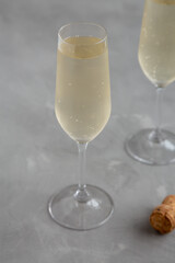 Cold Bubbly Champagne in a Glass on a gray background, side view.