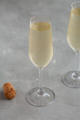 Cold Bubbly Champagne in a Glass on a gray background, side view.