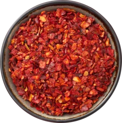  Bowl of dried paprika and hot pepper flakes, isolated. Pepper spice and paprika seasoning  closeup. Top view. © chamillew