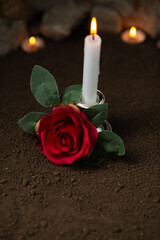 burning candle with red rose on a dark ground sci fi fantasy cosmic death