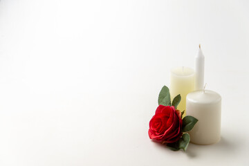 light candles with red rose on a white background flame lamp fire