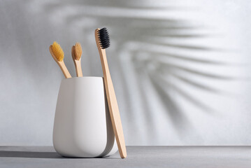 Natural bamboo toothbrush in a white cup