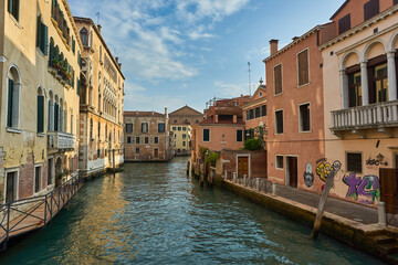 Obraz na płótnie Canvas Beautiful narrow canal with silky water in Venice