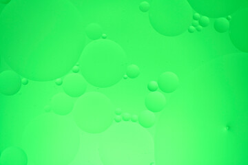 Abstract background with green oil circles on the water.