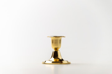 front view of golden candlestick on white background metallic steel lamp