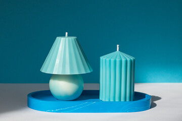 Handmade candles on a blue platter.