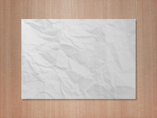 Crumpled white paper on brown wood texture	