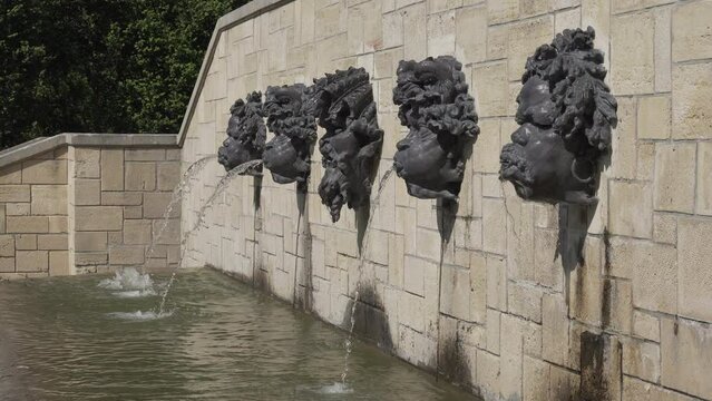 Water flowing out from Rodin's Mascarons in public Departemental Parc de Sceaux (Auguste Rodin - 1840-1917) - Hauts-de-Seine, France.