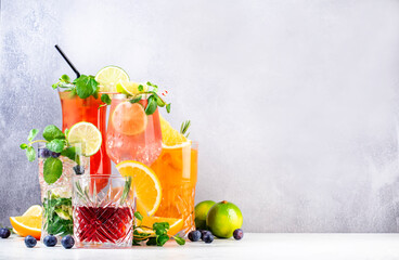 Trendy cocktails set: negroni, blueberry mojito, screwdriver, hurricane and french mule on gray background. Refreshing summer drinks