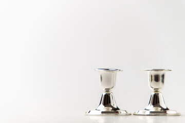 front view of silver candlesticks on a white background metallic steel lamp