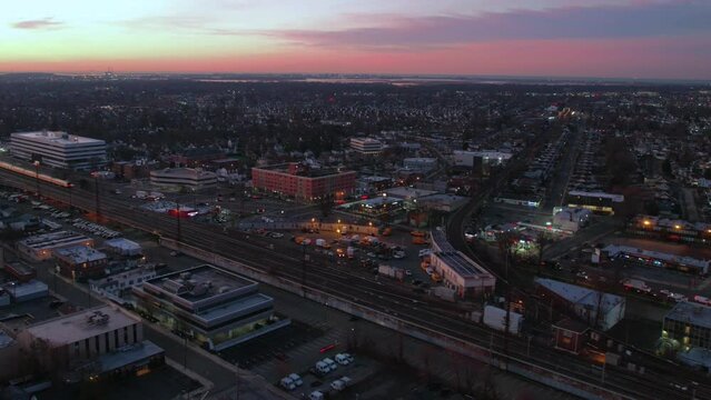 Aerial timelapse video of a busy train station at sunrise, Long Island, New York