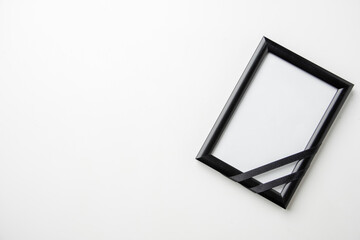 top view empty picture frame of deceased person on white desk death funeral