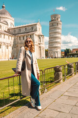 Travel tourists happy woman making selfie photo in front of leaning tower Pisa, Italy. High quality photo