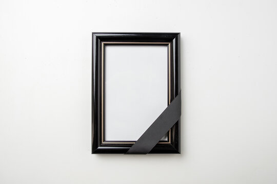top view empty picture frame of deceased person on white surface death funeral
