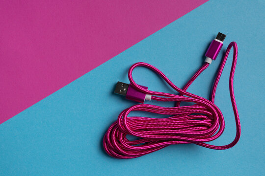 Pink color USB cable on bright background