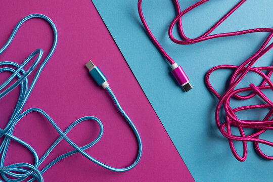 Multicolored USB cables on bright background