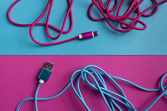 Multicolored USB cables on bright background