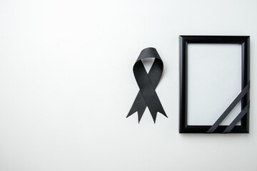 top view picture frame with black bow on white background funeral
