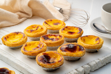 Egg custard tart dessert on wooden plate,traditional Portuguese dessert ,sweet food