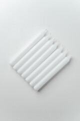 top view white candles on white background fire death funeral flame