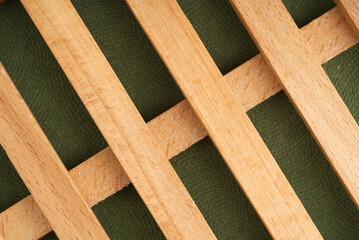 Wooden cage on a green background. Closeup