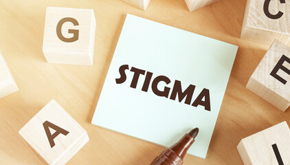 Sticker with text Stigma in the middle of wooden cubes with letters