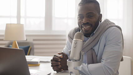 An African American man live streamer commenting on sports or cyber games and broadcasting them