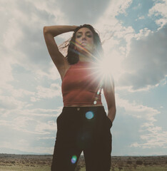 Beautiful Natural Light Portrait of Ethnic Female Model Standing Backlit Against a Lens Flare