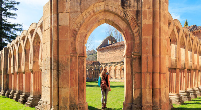 Woman tourist at San Juan cloister ruins at Soria in Castilla Spain- Travel in Europa