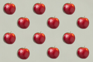 Red apples on the gray background. Flat lay. Pattern. Top view.
