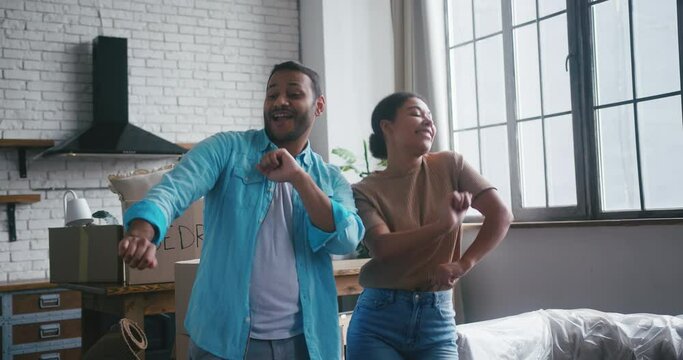 Married couple dances together celebrating house purchase