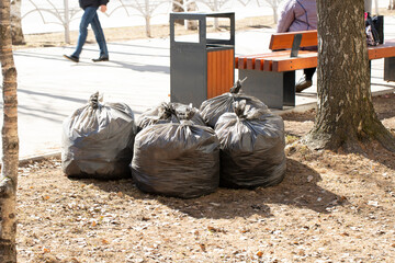 Garbage collection in the spring in the city.Garbage bags on the street.