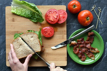 Making a BLT sandwich on a cutting board