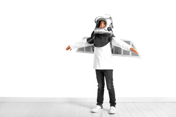 A young boy imagines that he is flying in a pilot's helmet