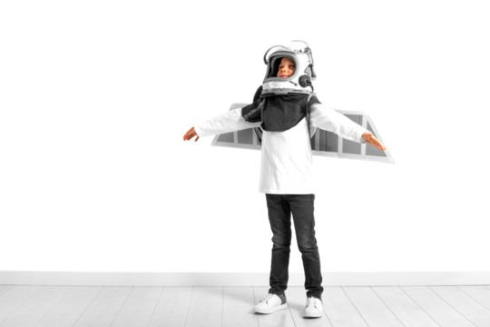 A young boy imagines that he is flying in a pilot's helmet