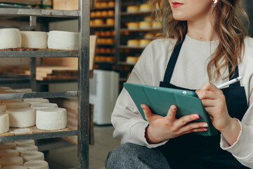 Young Farm Female Owner Controls Maturing Process of Goat Cheese Heads