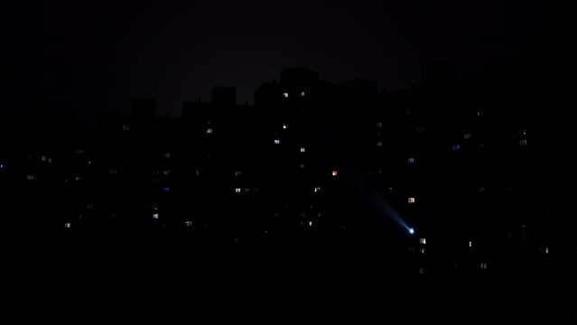A rolling blackout in an area of high rise apartment buildings during war time in Kyiv, Ukraine. The footage could illustrate an economic or global energy crisis.