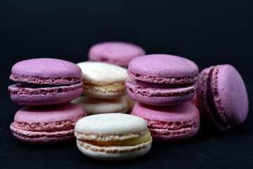 Multicolored cookies on a black background. Macaroni cookies close-up.Delicious and sweet cookies.