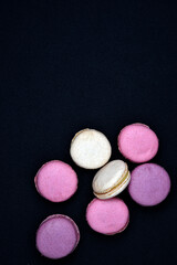Multicolored cookies on a black background. Macaroni cookies close-up.Delicious and sweet cookies.