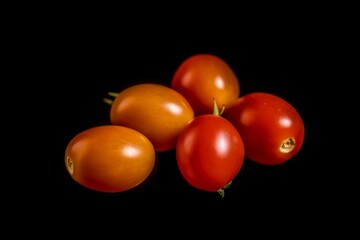 Close up of tomatoes on black background with copy space - Generative AI 