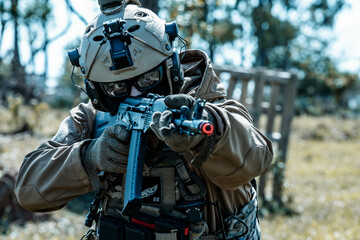 Anonymous soldier with AK-47 in the middle of the battlefield