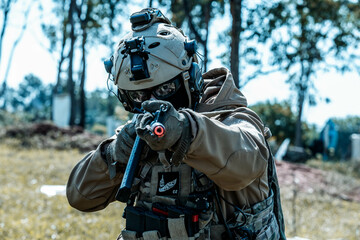 Anonymous soldier with AK-47 in the middle of the battlefield