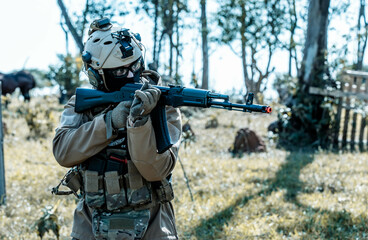 Anonymous soldier with AK-47 in the middle of the battlefield