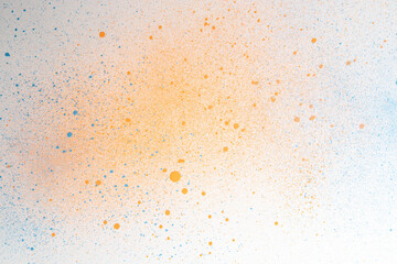 Fototapeta na wymiar above view orange paint with blue spots on white surface painting art horizontal exhibition artist color photo dust