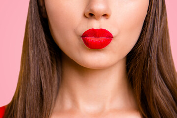 Close up half face portrait of young woman with red lips sand a kiss isolated on bright yellow background